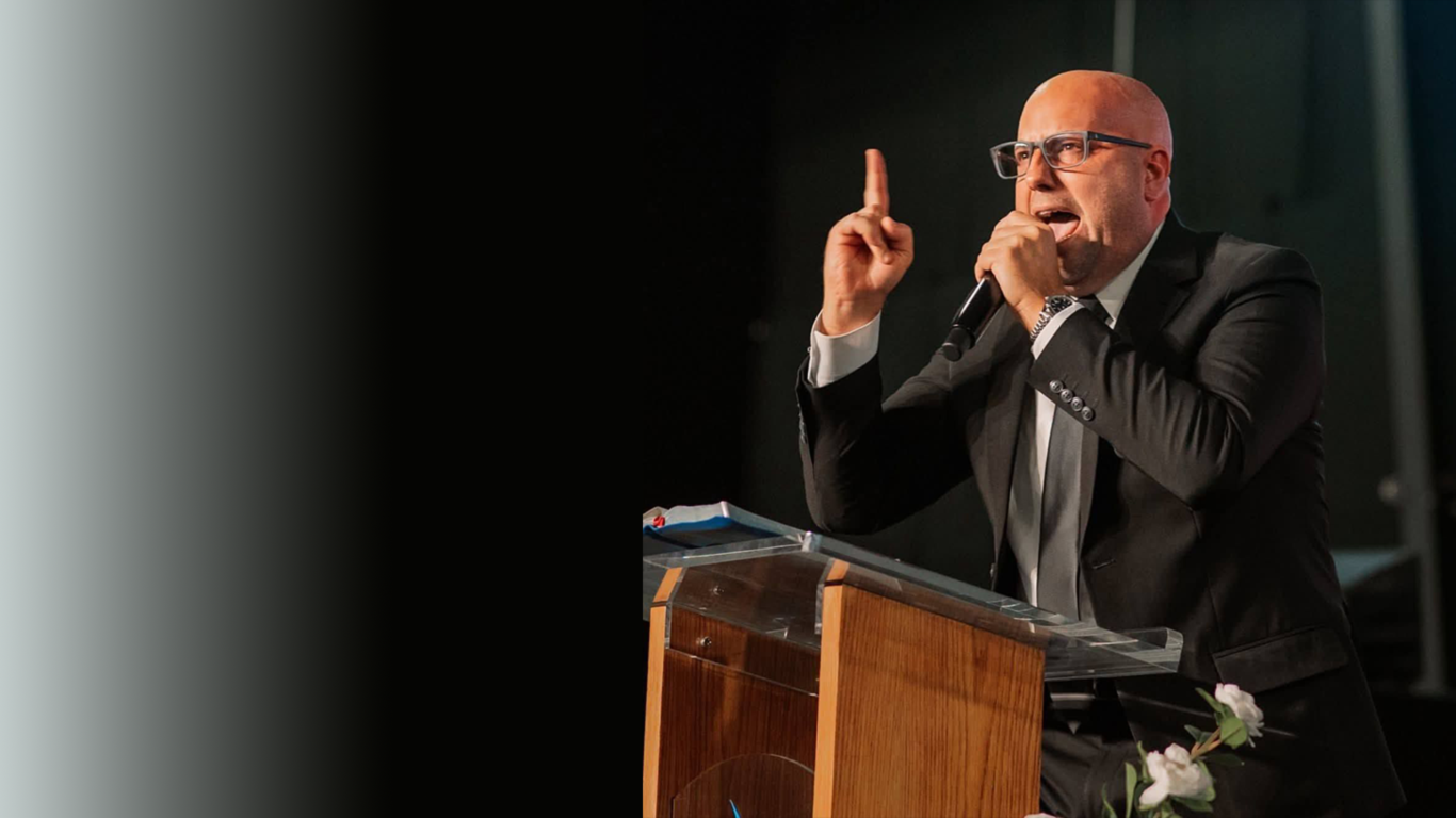 Evangelist speaking at a podium